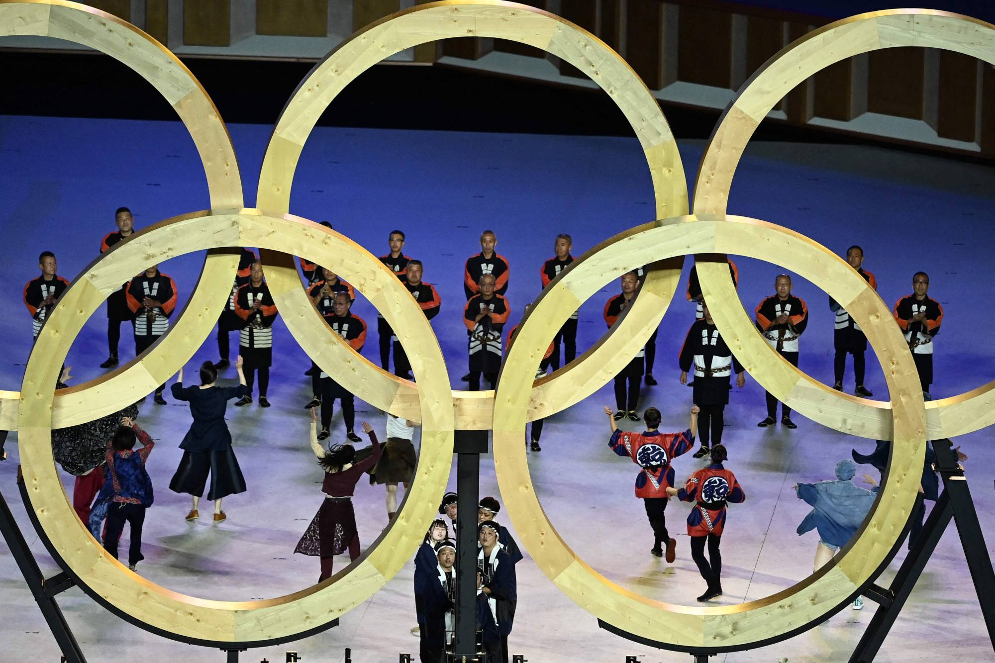 Performers assemble the Olympic Rings during the opening ceremony on Friday. | AFP-JIJI